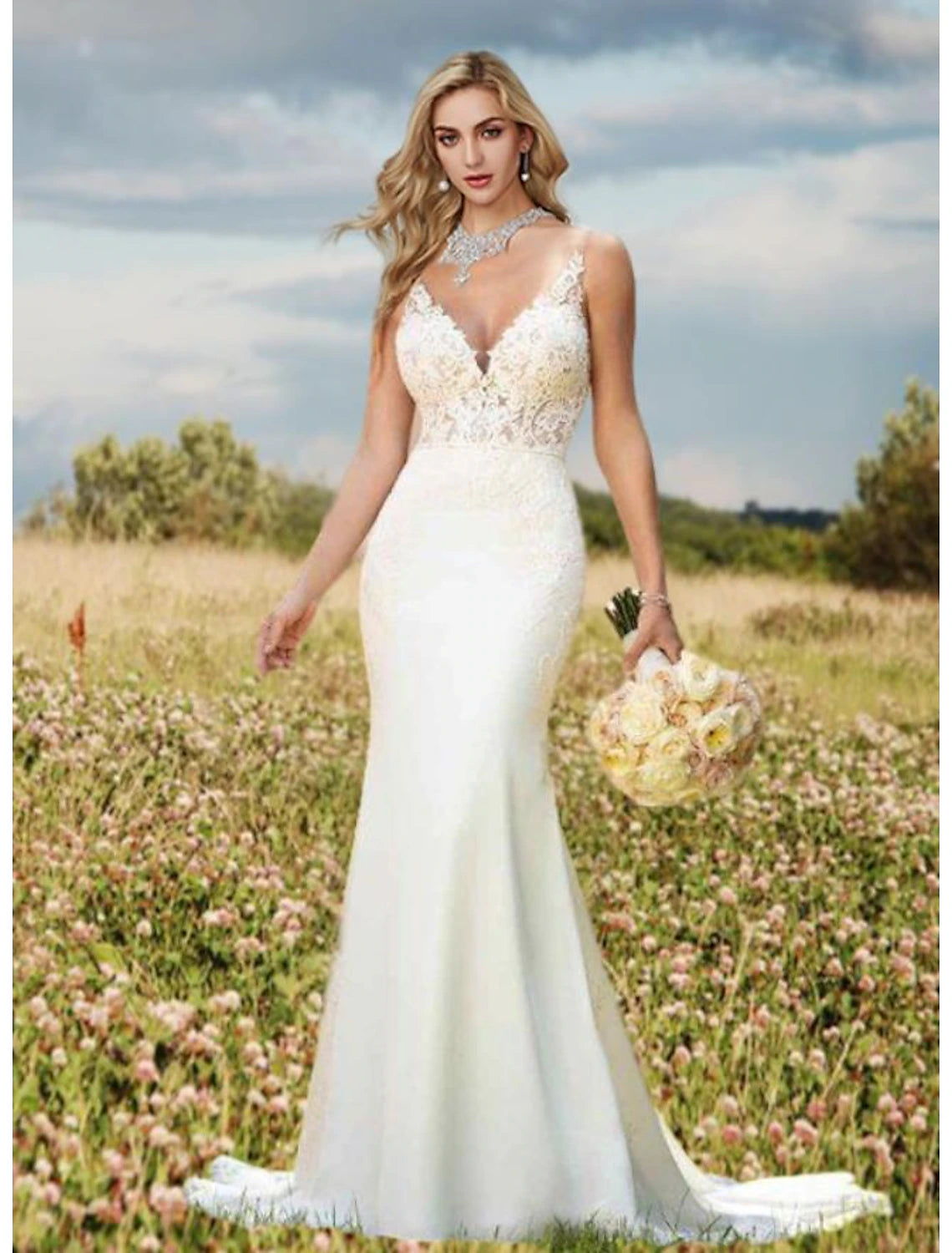 Sleeveless ivory mermaid wedding dress featuring lace appliques and court train