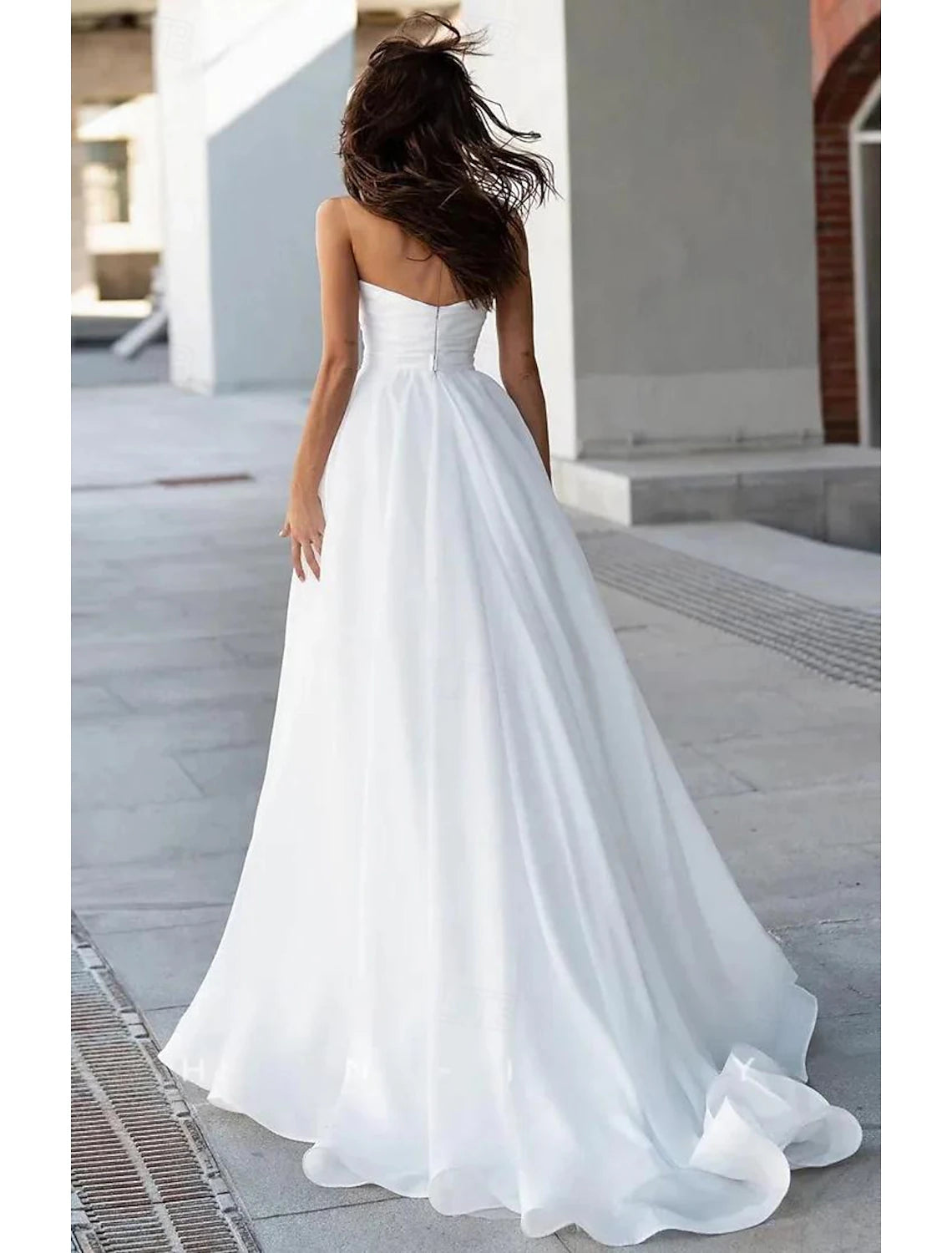 Sleeveless boat neck A-line tulle bridal gown featuring sweep train