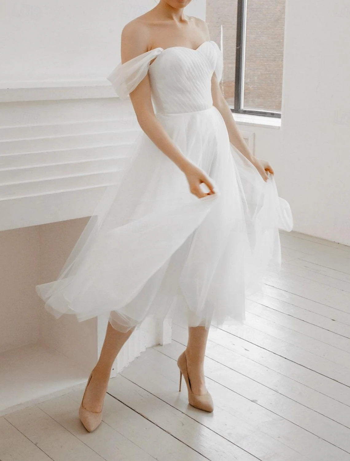 Ruched tea-length chiffon bridal dress in white with an A-line silhouette
