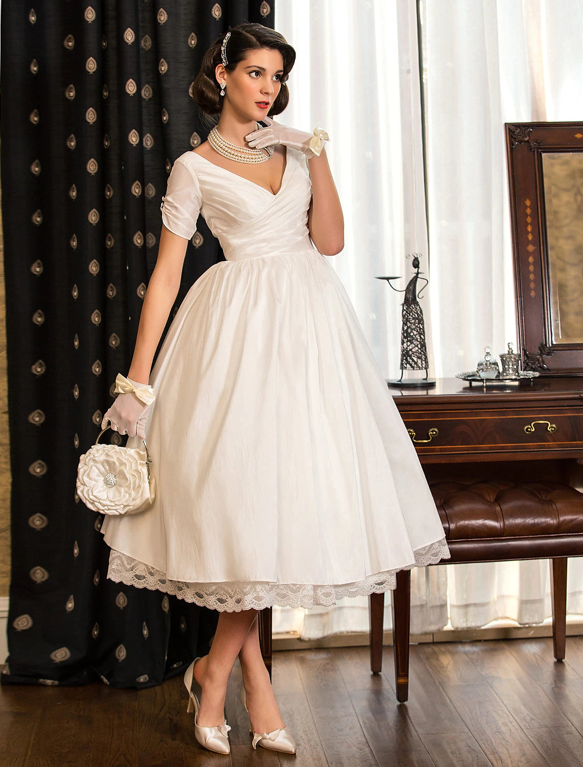 Vintage 1950s tea length A-line satin bridal gown with short sleeves and lace criss cross