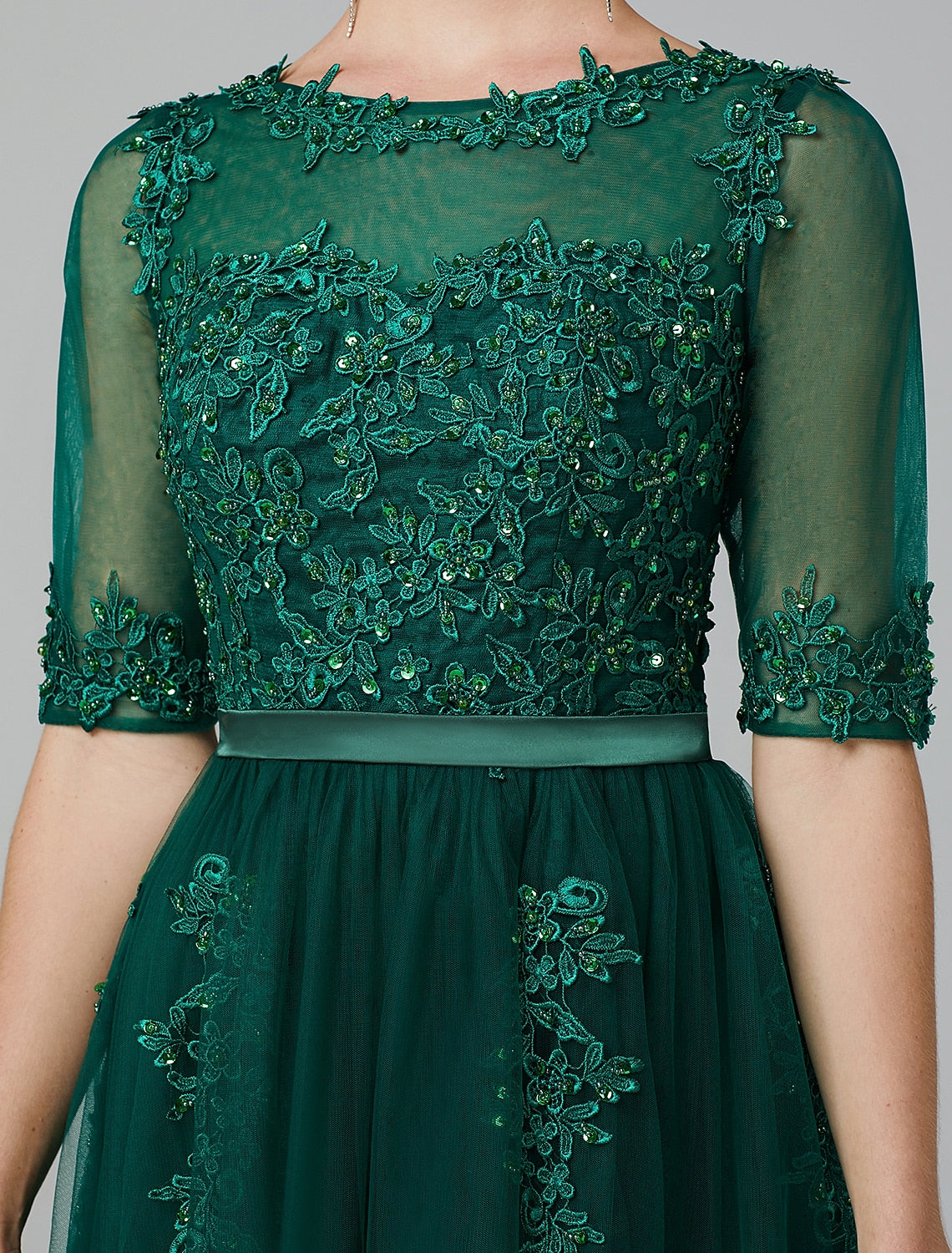 Detailed look at the sequin appliques and lace over tulle fabric