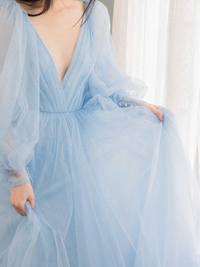 A-line tulle prom dress with ruffles, long sleeves, and brush train