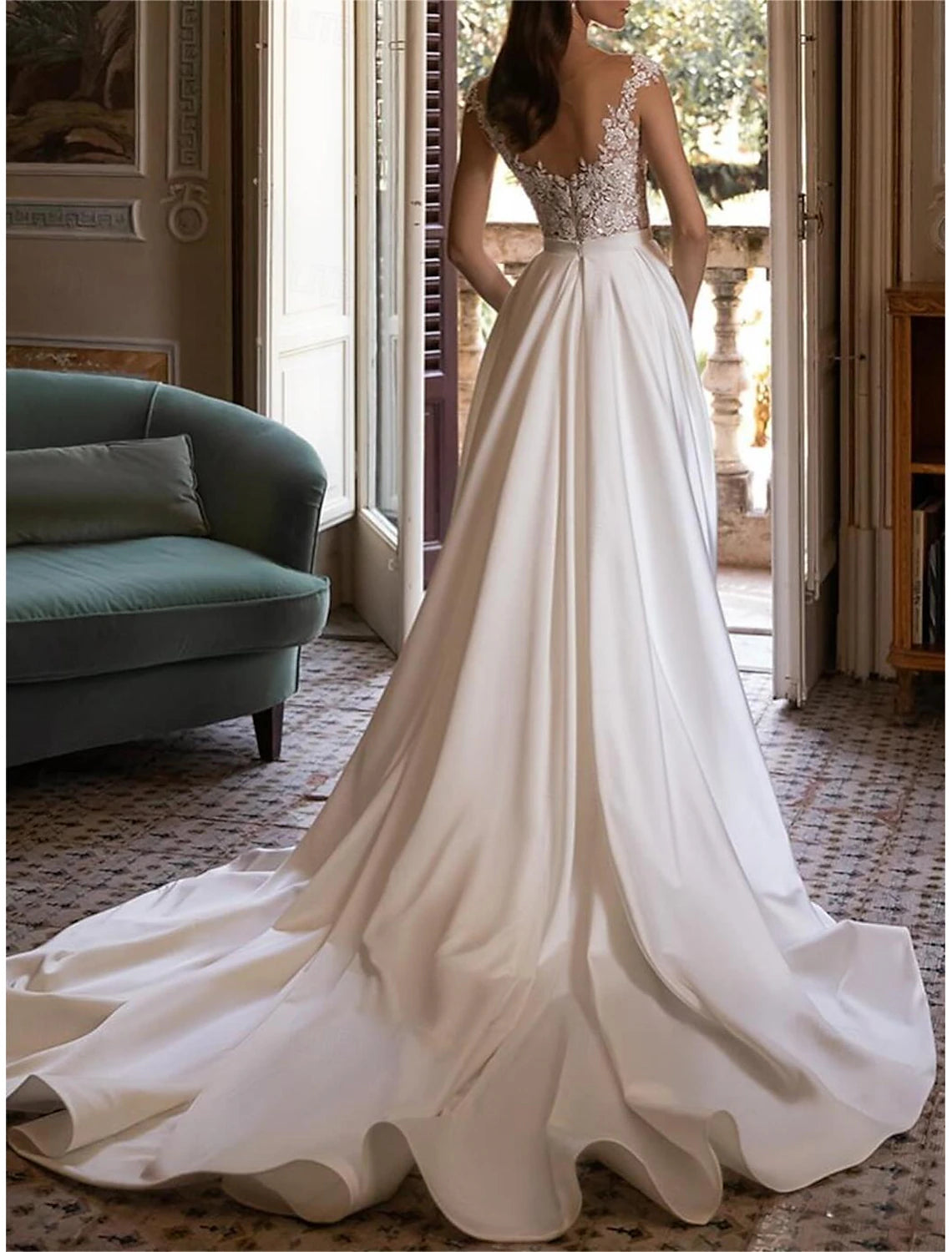 Ivory satin ball gown bridal gown featuring off-the-shoulder neckline and chapel train