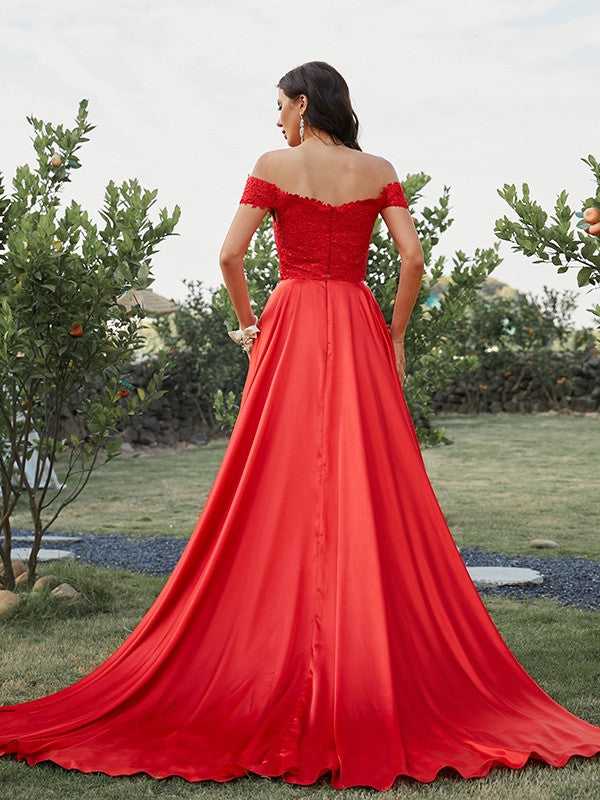 Detailed view of silk-like satin fabric and applique on two-piece prom dress