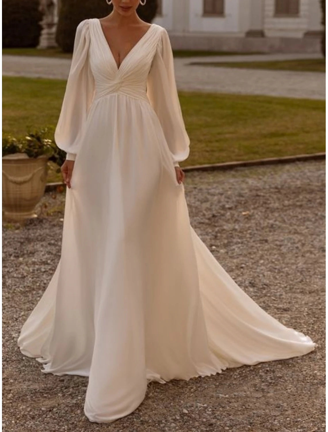 Tea length chiffon wedding dress featuring camisole straps and pleated details in ivory
