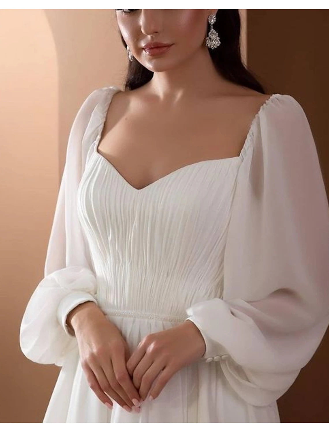 Pleated chiffon wedding dress with beaded accents and elegant court train
