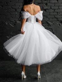 Tea length A-line satin bridal gown featuring scoop neck and sleeveless design