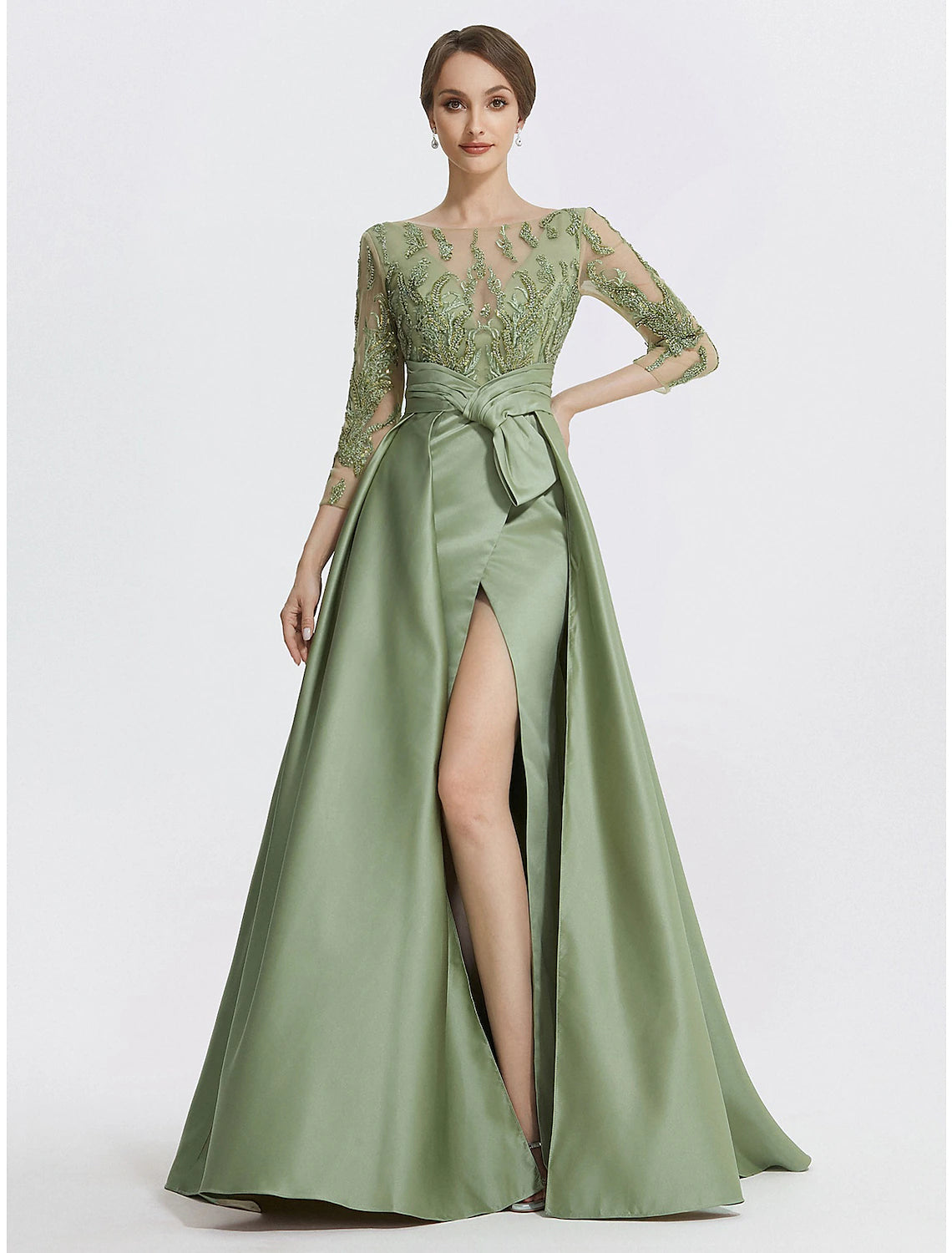 A-line satin evening gown in Clover featuring a jewel neck, 3/4 length sleeves, embroidery appliques, and a slit