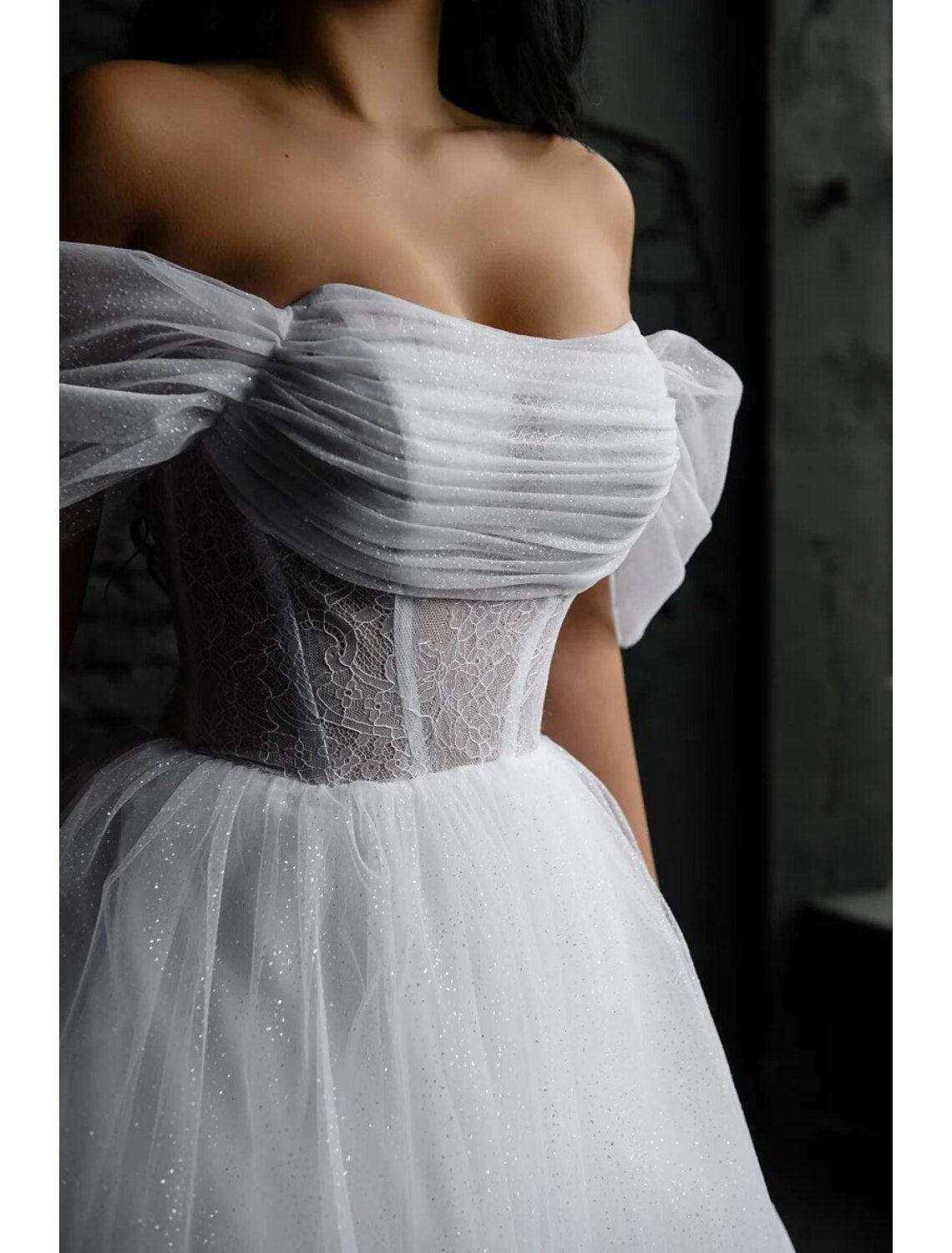 Sleeveless tea length satin wedding dress with scoop neckline and A-line silhouette