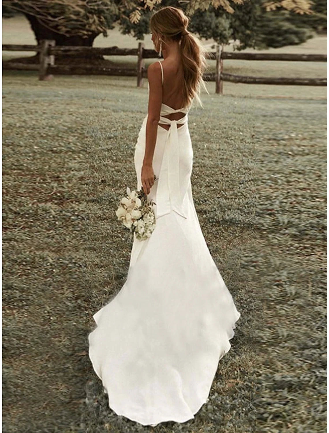 Stretch fabric sheath bridal gown showing sweep brush train and ruched front split