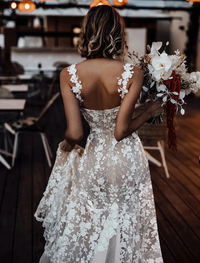 Ivory A-line bridal gown featuring sweetheart neckline, lace appliques, and court train