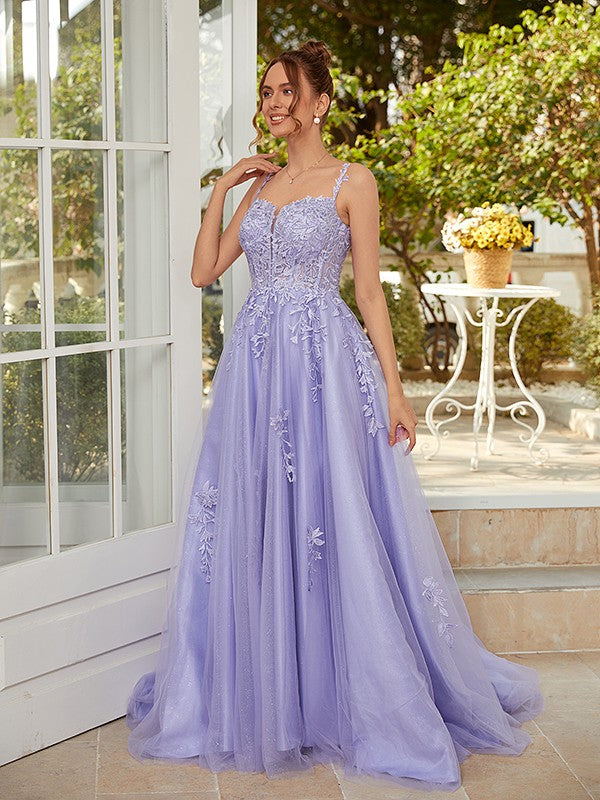 A-line tulle prom dress with straps, applique, and court train