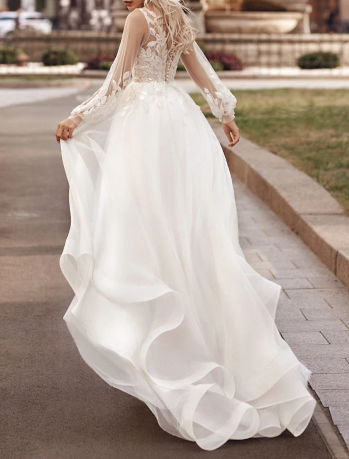 A-line lace applique bridal gown with court train and long sleeves in Ivory