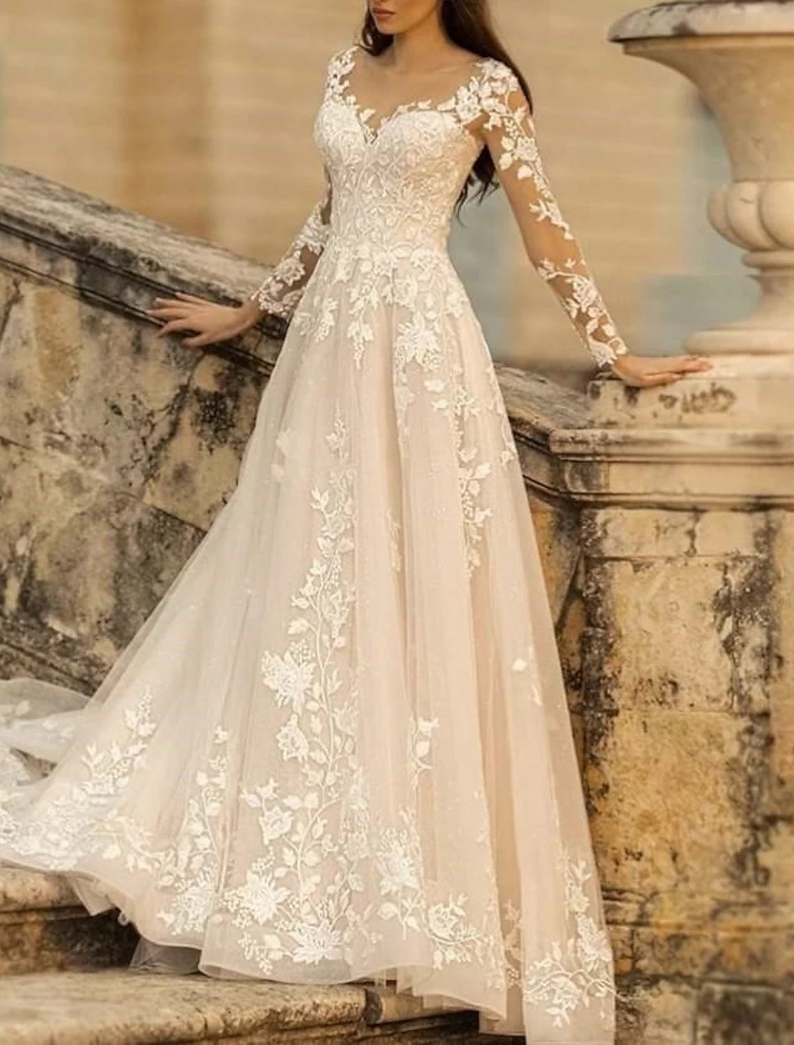 Ivory A-line lace wedding dress with V-neck, long sleeves, and flower details