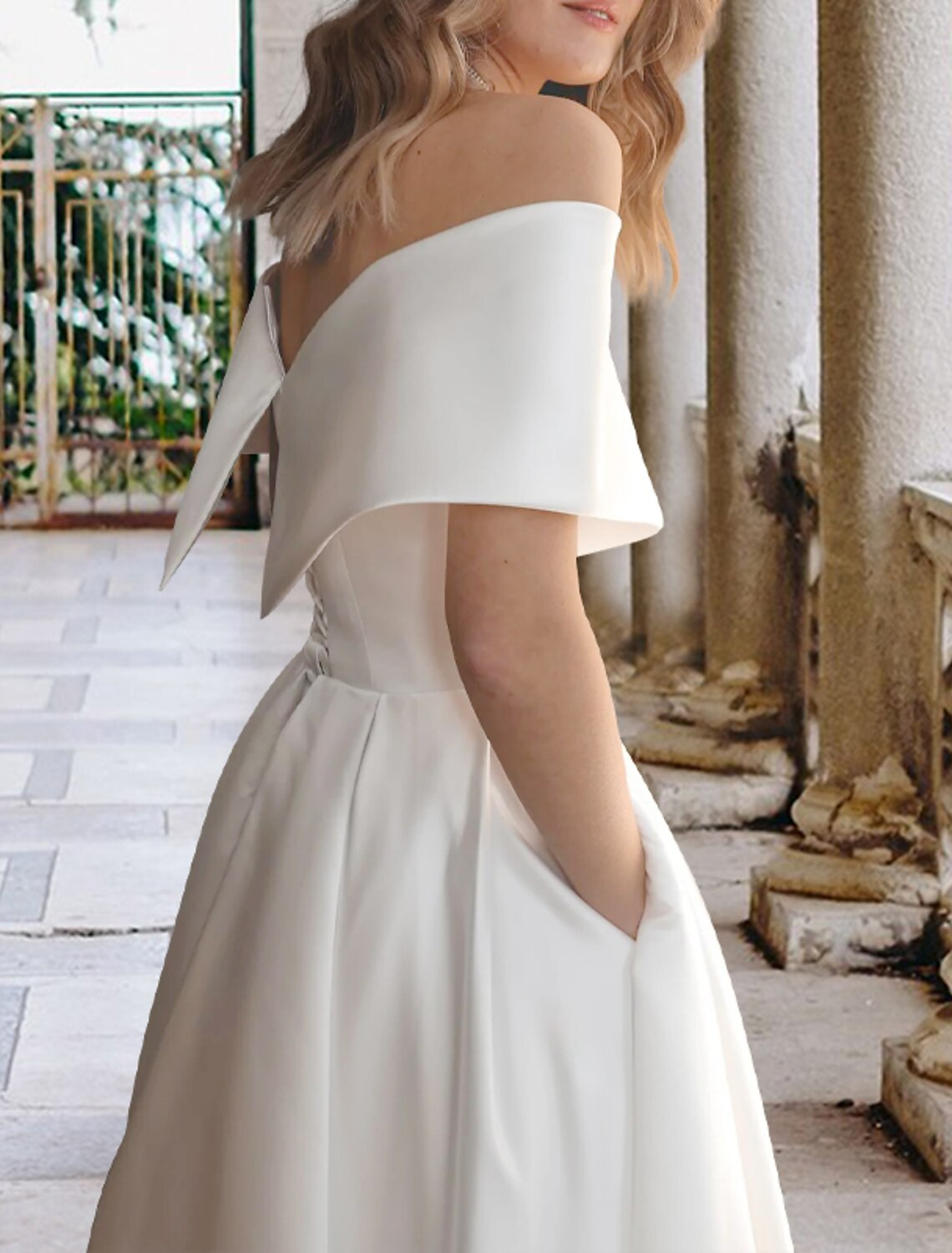 Tea-length ball gown wedding dress with lace appliques and pleats in ivory
