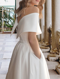 Tea-length ball gown wedding dress with lace appliques and pleats in ivory