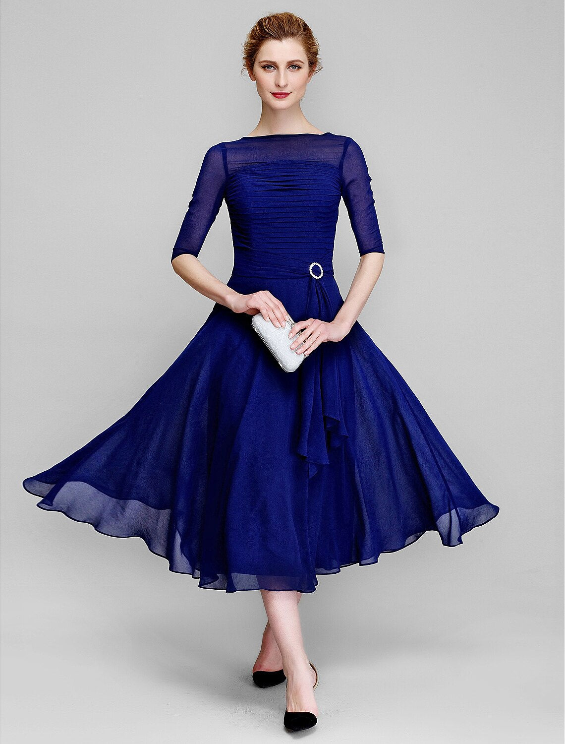 A-line mother of the bride dress in tea length chiffon with bateau neck and ruched half sleeves
