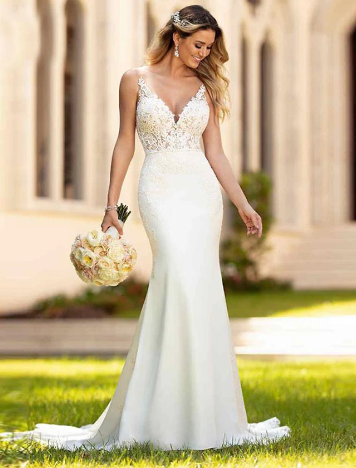 Ivory sleeveless mermaid wedding dress with V-neck and lace appliques