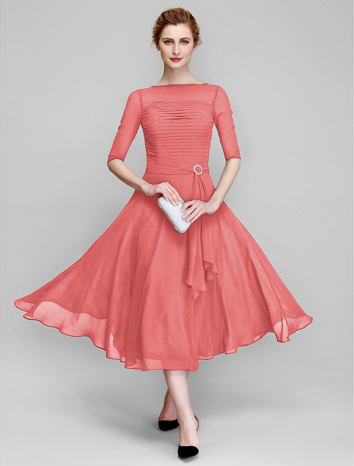 Mother of the bride dress featuring an A-line chiffon skirt and ruched half sleeves