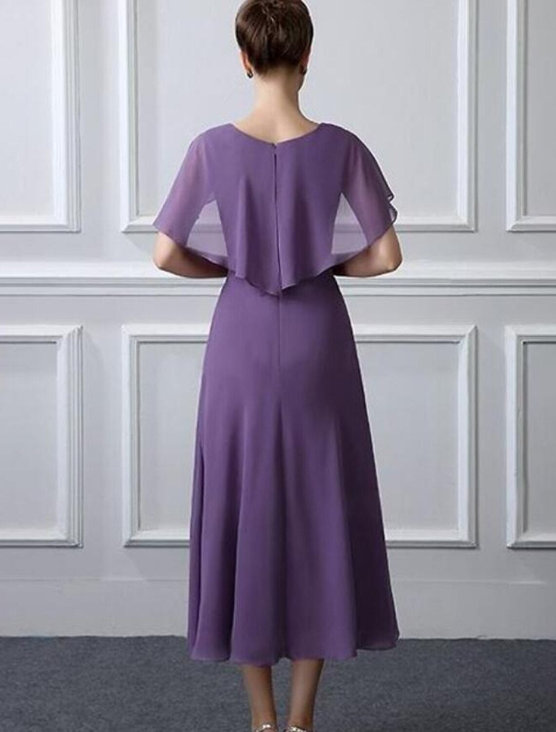 Side view of chiffon tea-length mother of the bride dress featuring short sleeves and ruffles