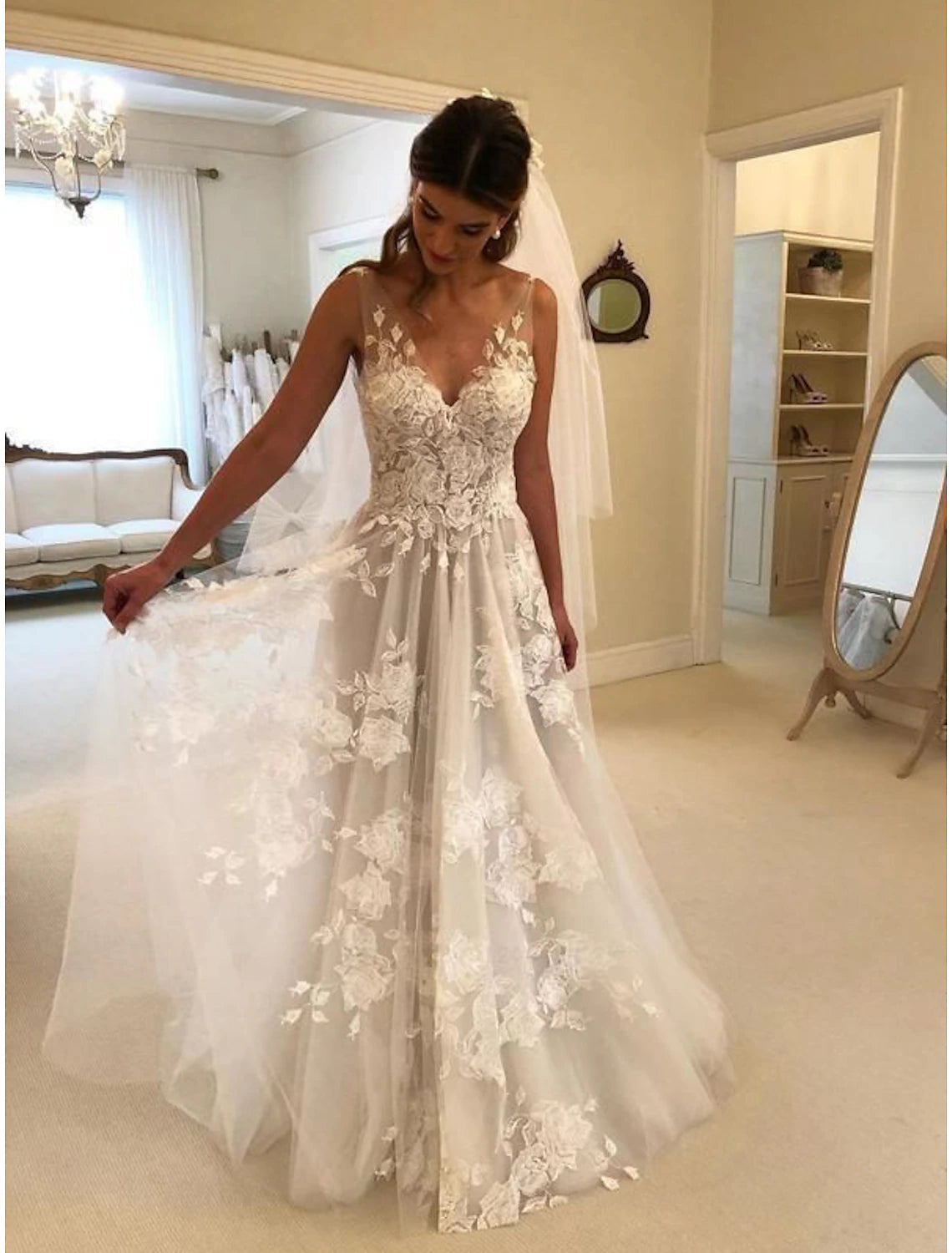 A-line sleeveless V-neck lace wedding dress with appliques and sweep train in Ivory