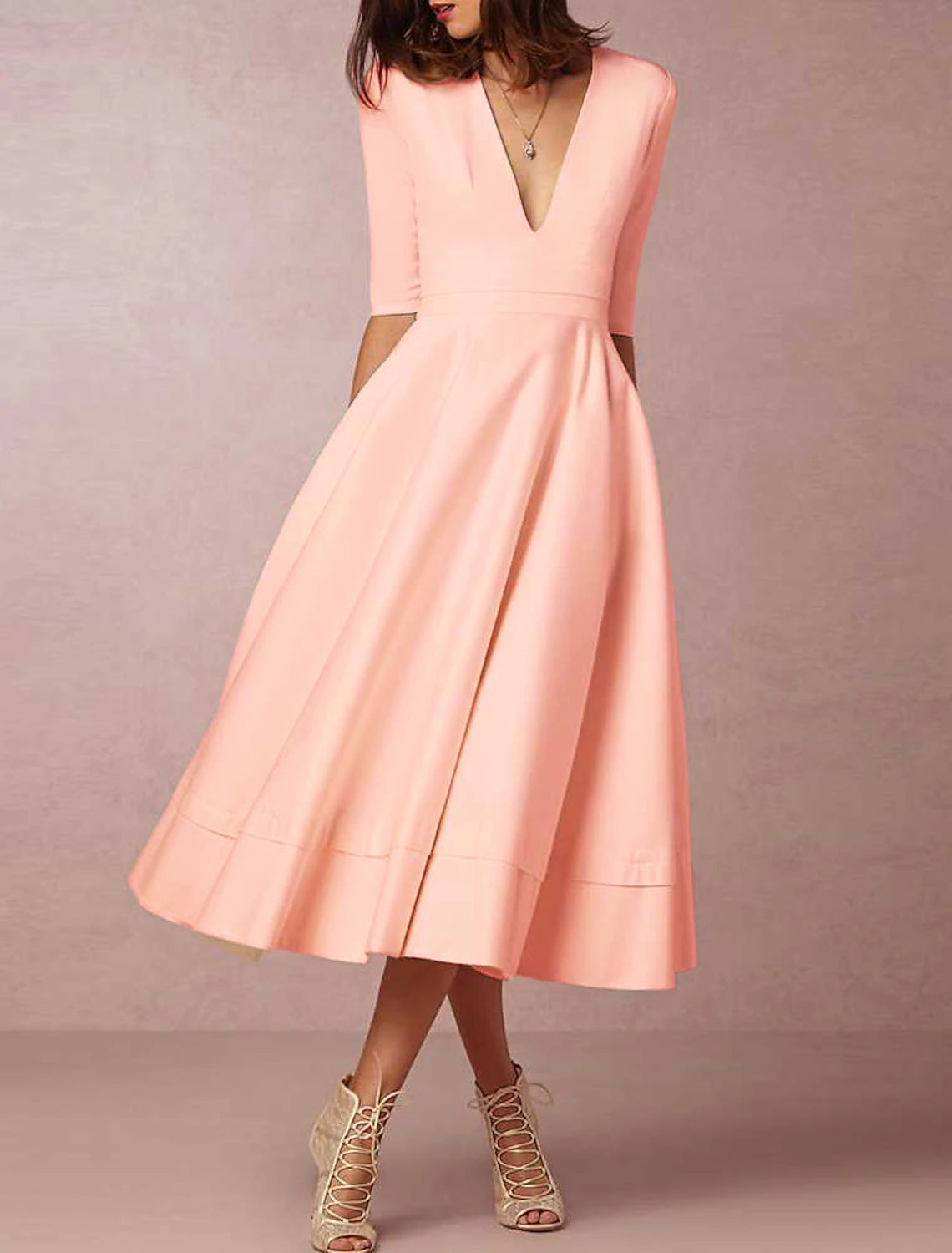 Simple satin bridal gown with pleats, ruched detailing, and court train