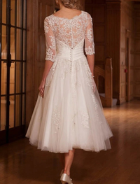 A-line tea length lace bridal gown with lace insert in ivory