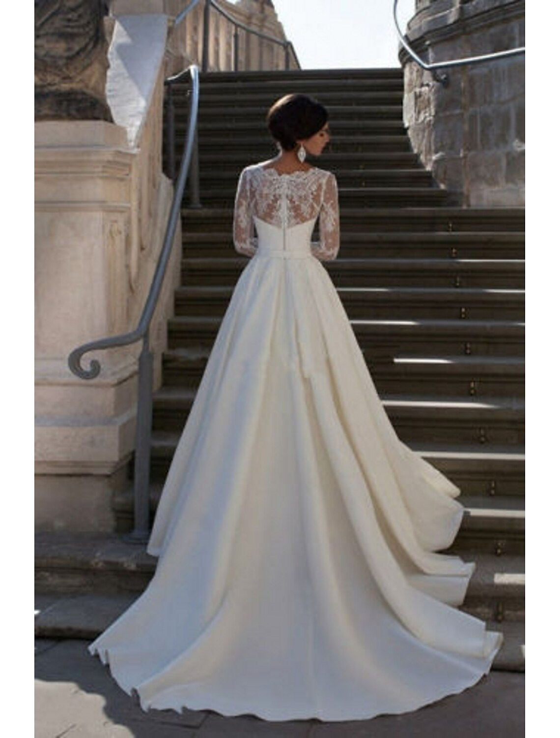 A-line satin bridal gown with long sleeves, appliques, and court train