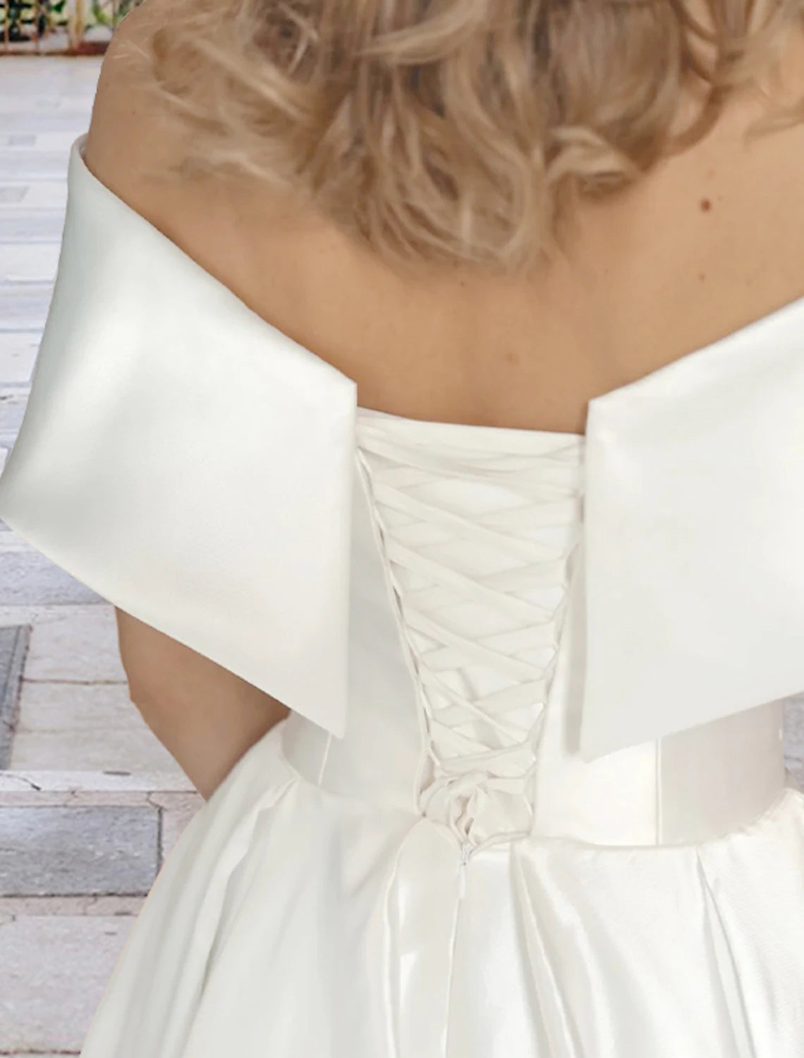 Ivory tea-length ball gown reception wedding dress with pleats and lace detailing