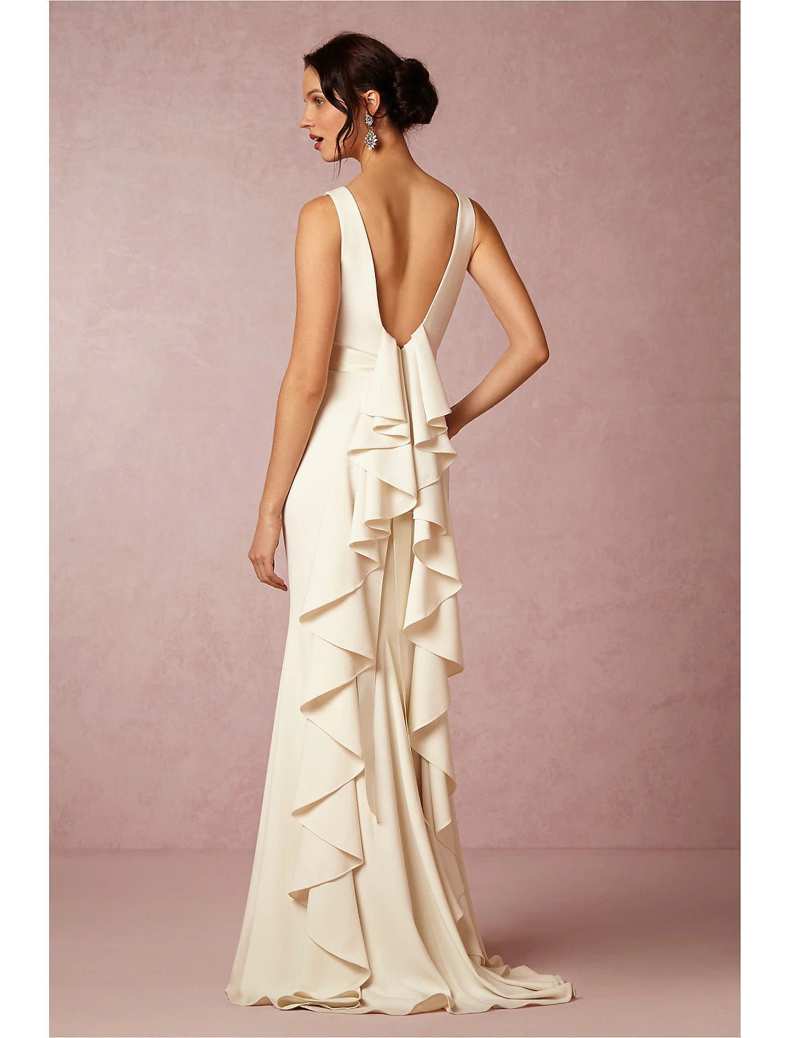 Back view of open back column bridal gown with draping and sweep train