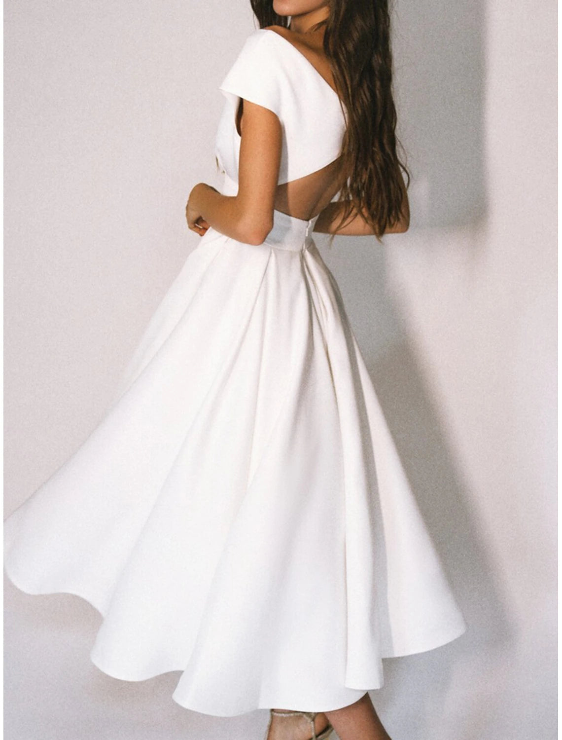 Ivory pleated tea-length chiffon bridal gown featuring cap sleeves and an A-line skirt