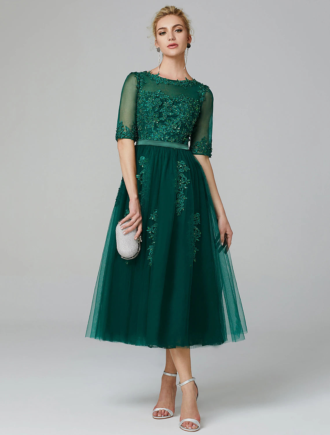 A-line tea length cocktail dress with sleeveless illusion neck and sequin appliques over tulle