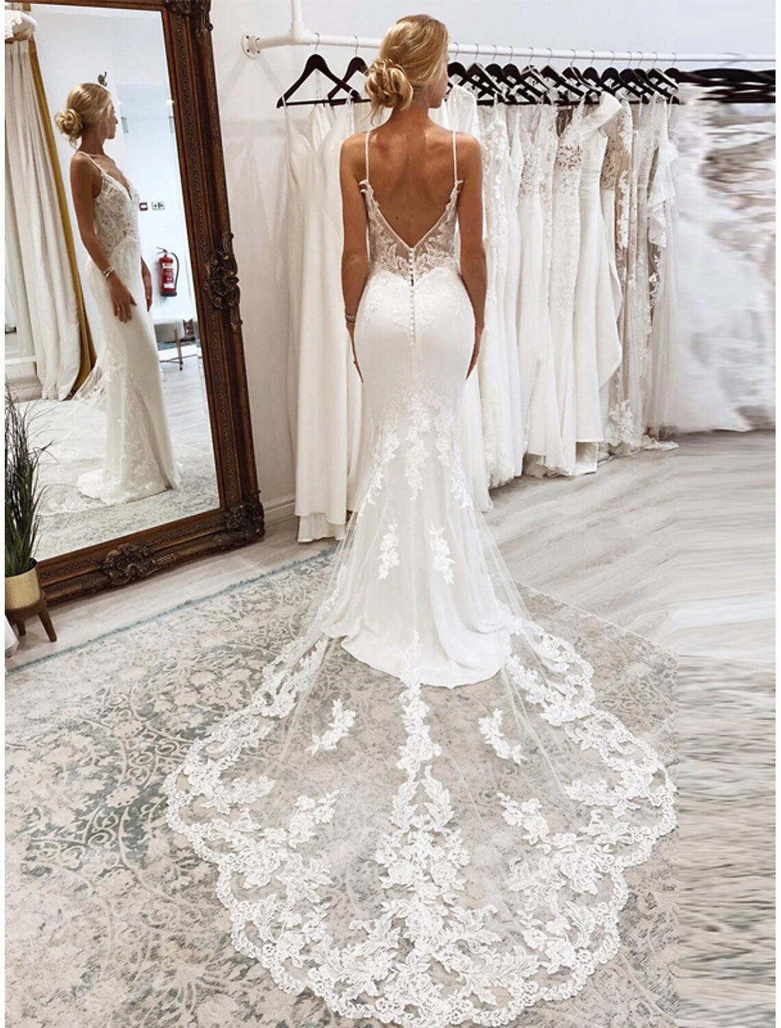 Back view of sleeveless tulle mermaid bridal gown showing the court train