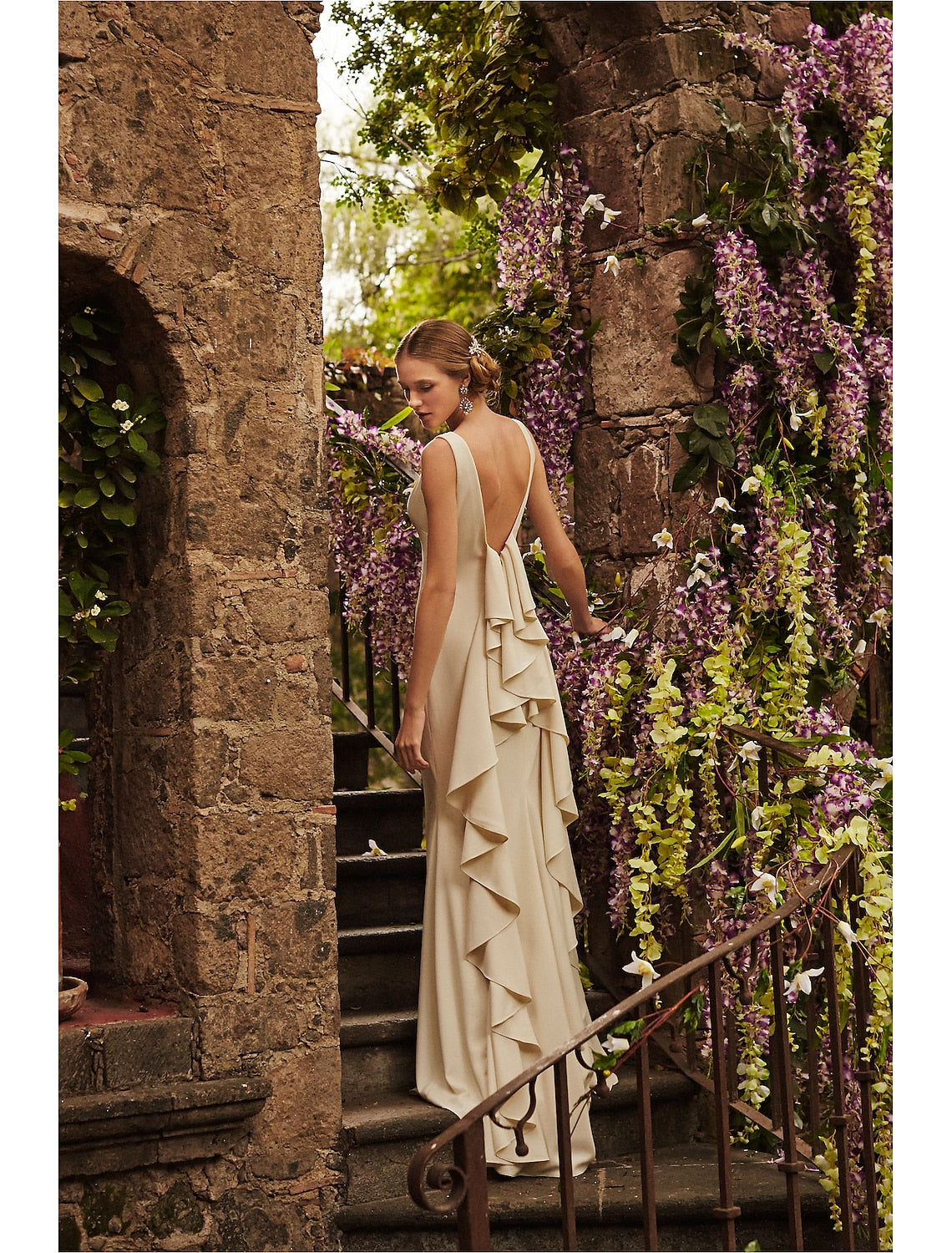 Close-up of sleeveless scoop neck bridal gown with stretch fabric draping