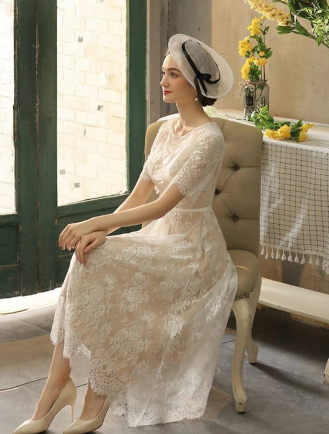 Tea length A-line lace bridal gown with half sleeves and sash ribbon in champagne