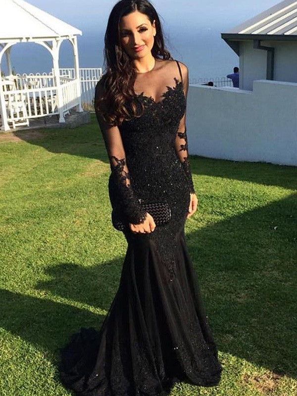 Sheer neck trumpet/mermaid applique tulle prom dress featuring long sleeves and sweep brush train