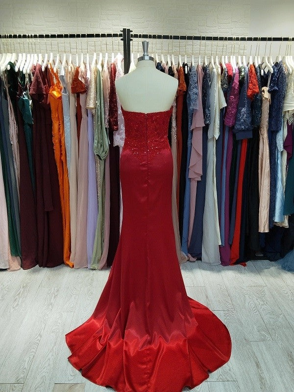 Rear view of red sequin sheath prom dress showcasing the court train