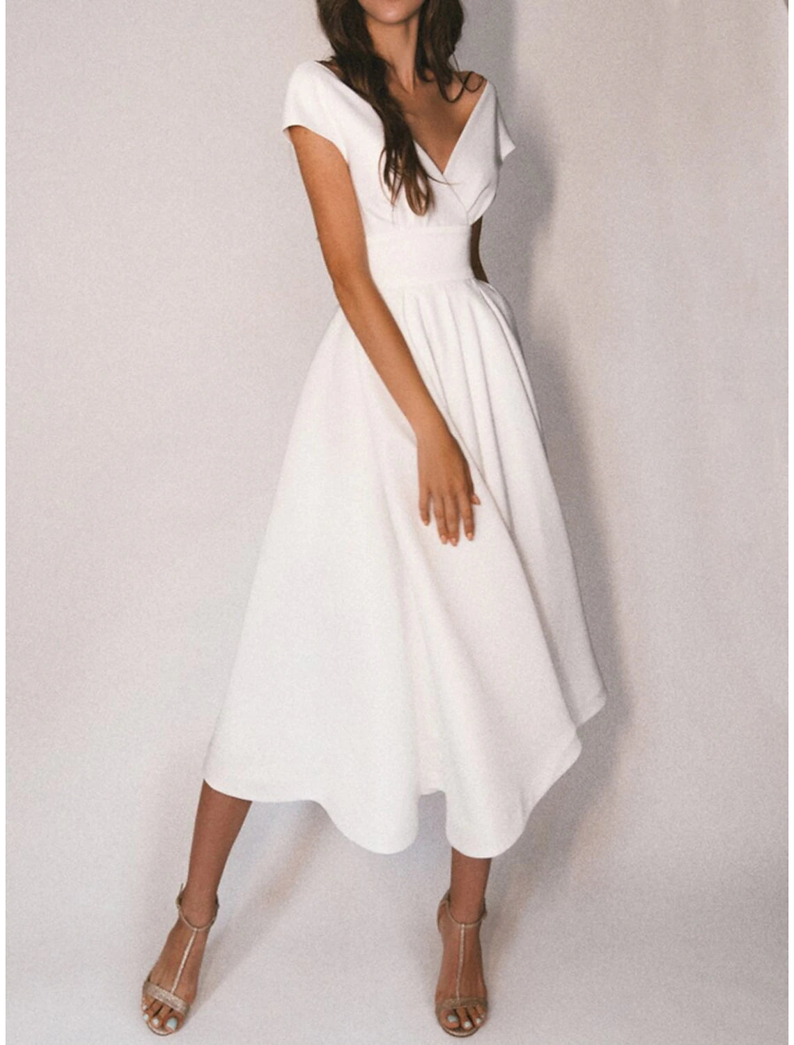 Front view of Ivory A-line V-neck cap sleeve tea-length chiffon wedding dress with pleats