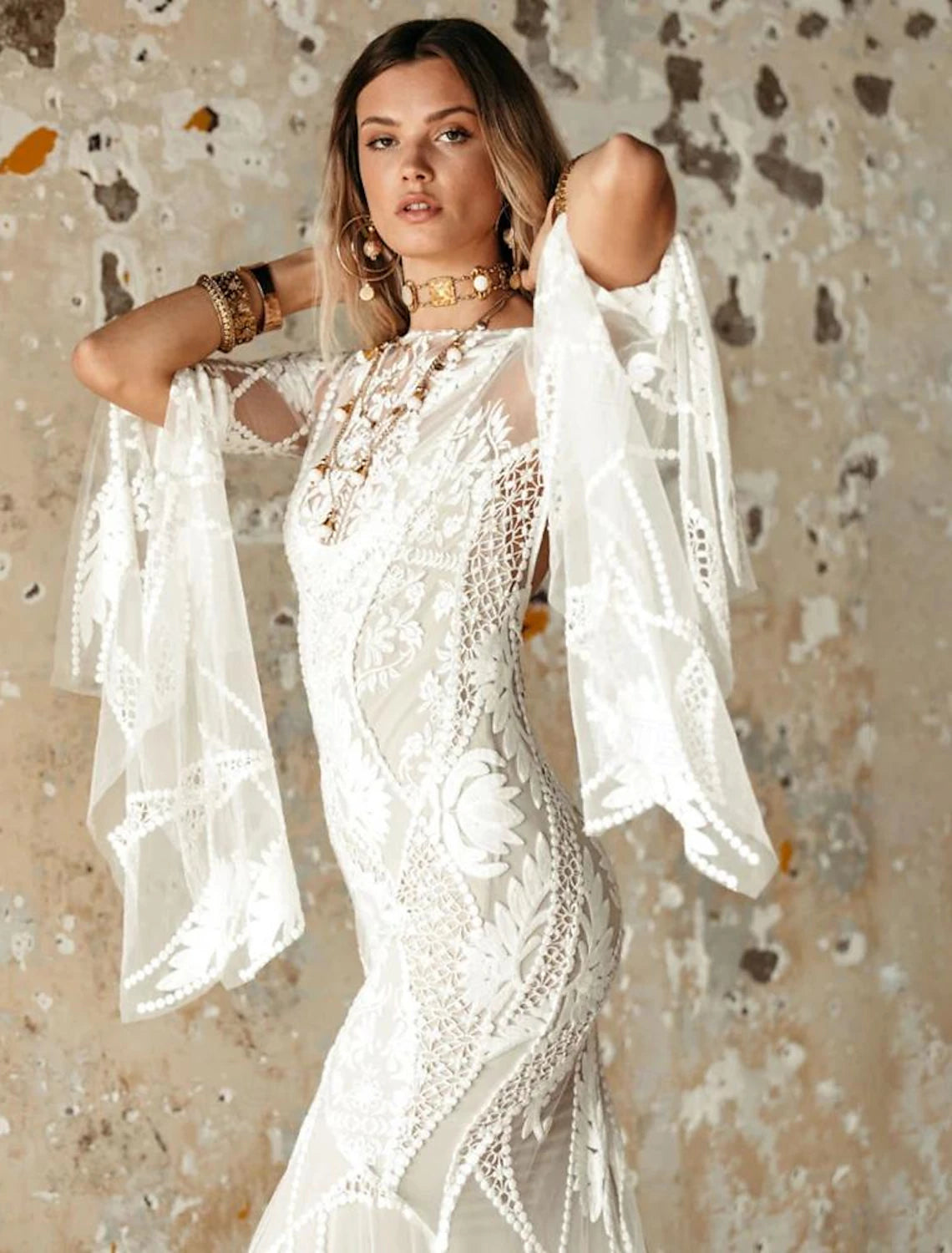 Patterned lace mermaid wedding dress with long sleeves and open back