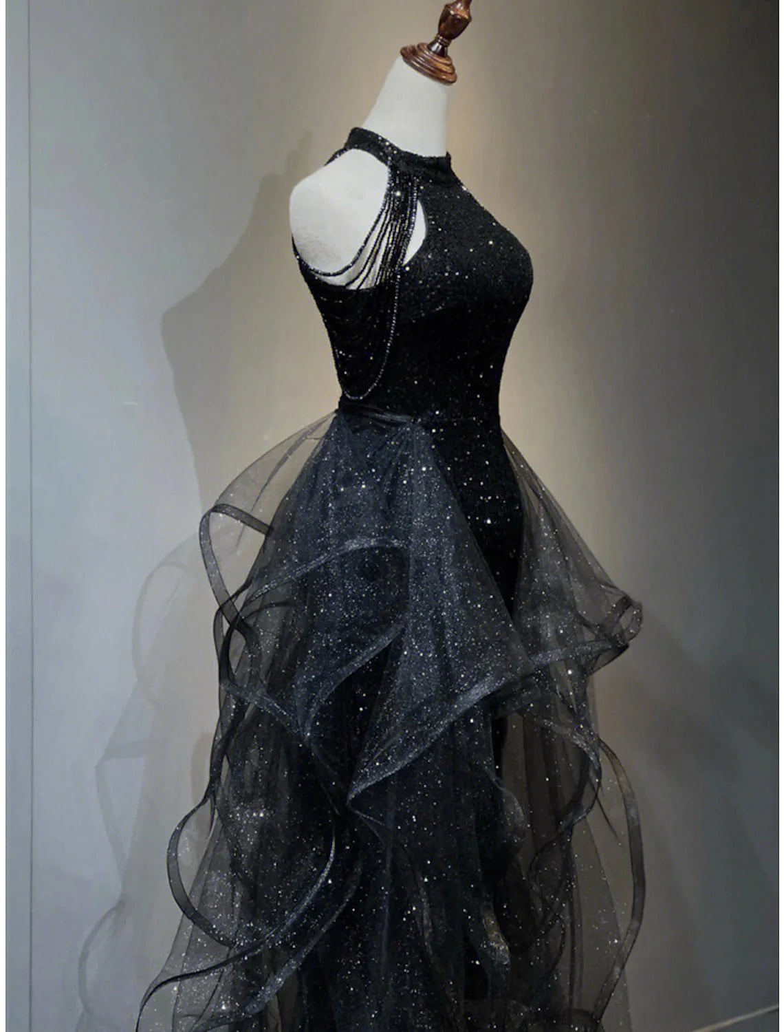 Detail of sparkling sequined halter neckline embellished with crystals