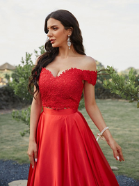 Back view of two-piece silk-like satin prom dress highlighting the brush sweep train