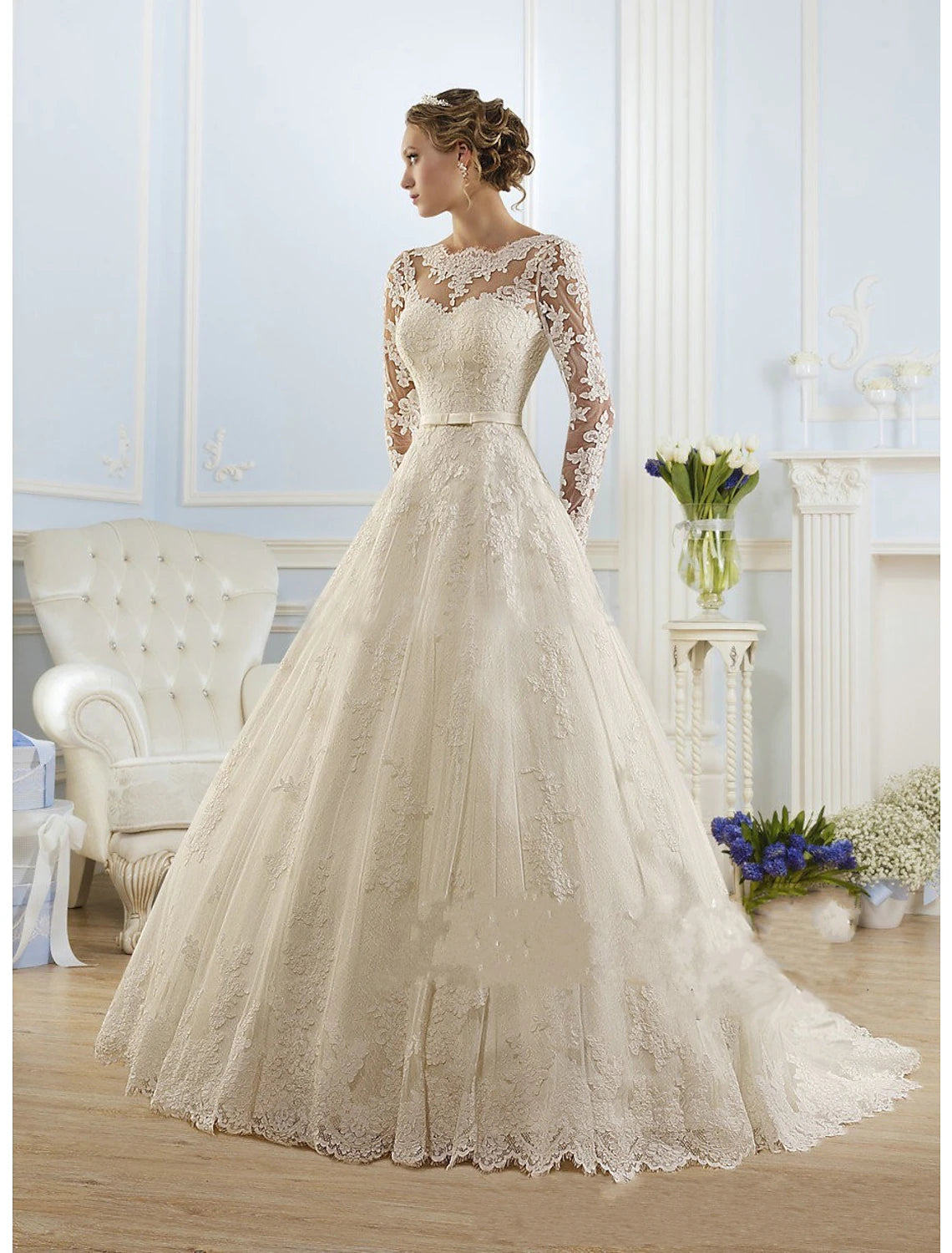 Front view of ivory lace ball gown wedding dress with illusion neckline and long sleeves