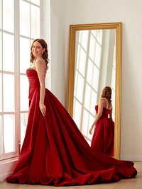 Satin sheath prom dress with ruched bodice, spaghetti straps, and chapel train