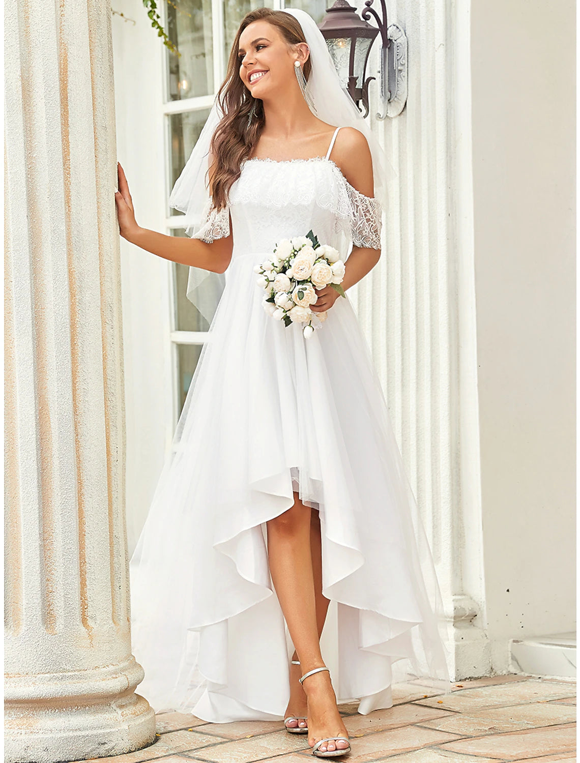 Front view of asymmetrical A-line lace bridal gown with off-shoulder neckline