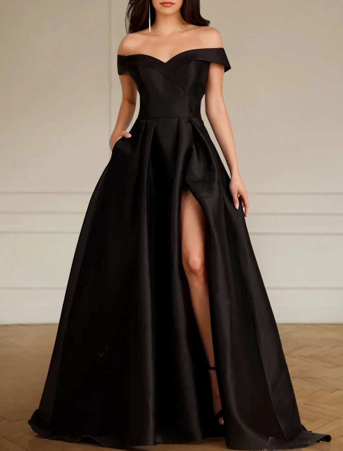 Off-the-shoulder A-line black satin wedding dress with front split and pleated detailing