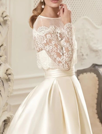 Floor length vintage satin A-line bridal gown with illusion neckline and long sleeves