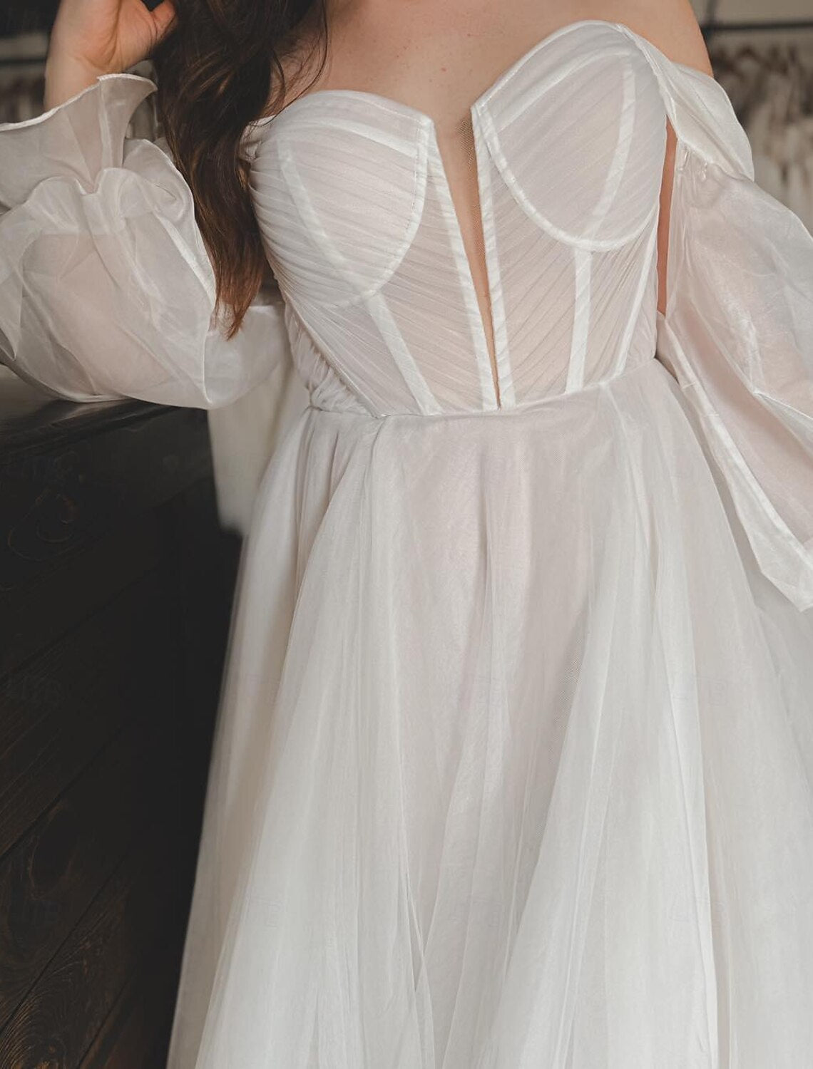 White A-line chiffon bridal gown featuring off-the-shoulder sleeves and court train