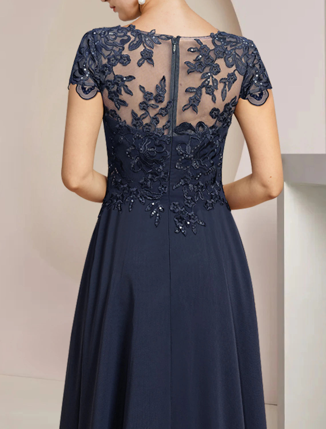 High-low A-line mother of the bride dress featuring scoop neckline and short sleeves