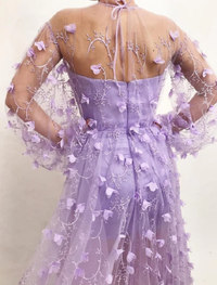 Back view of floor-length A-line prom and wedding guest dress in tulle with floral appliques