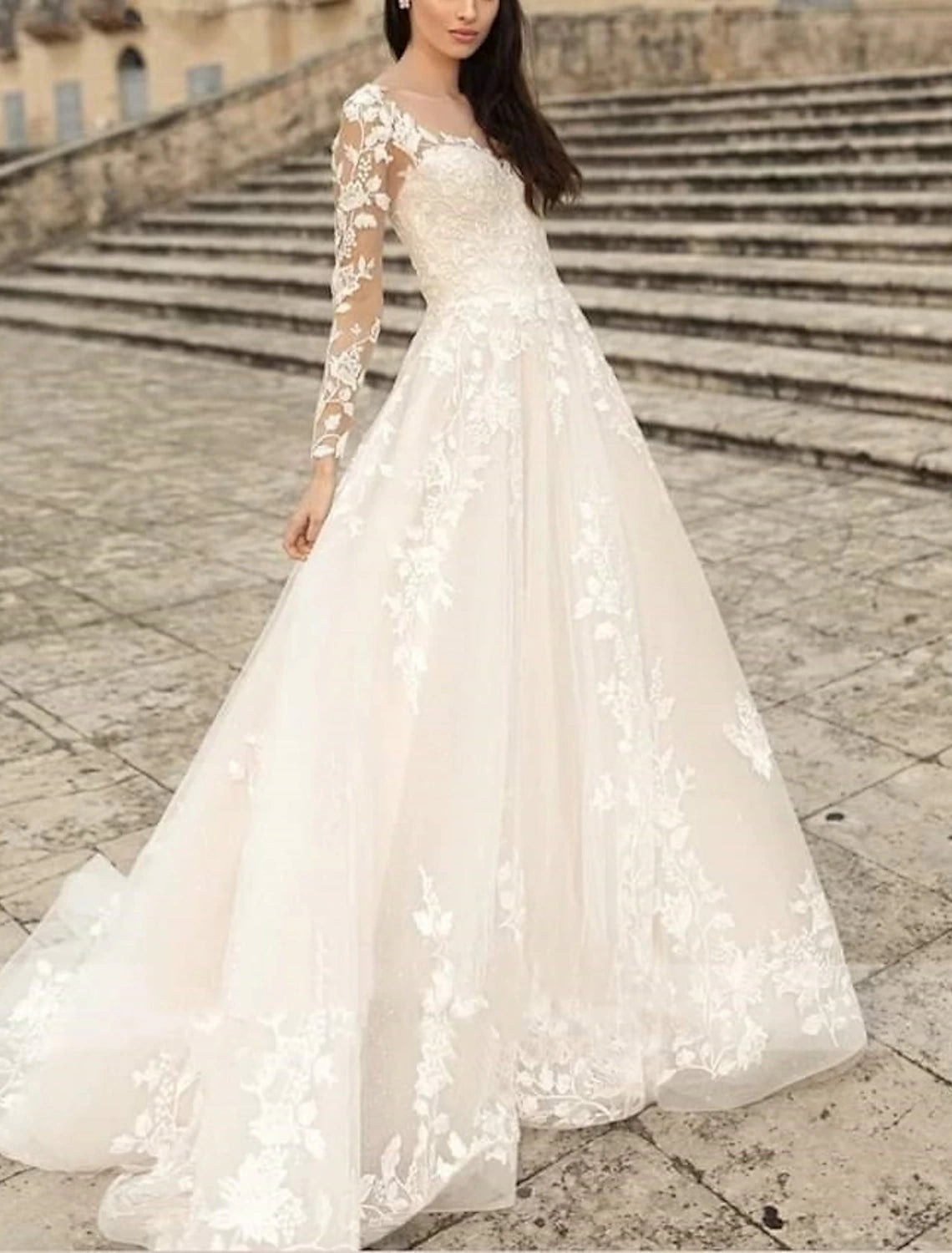 Rear view of A-line wedding dress featuring a sweep brush train